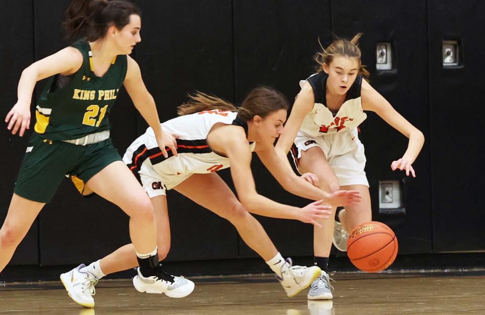 Oliver Ames Maddie Homer, center, and Annie Reilly take the basketball away from King Phillip's Jaclyn Bonner during a game on Tuesday, Dec. 20, 2022.  