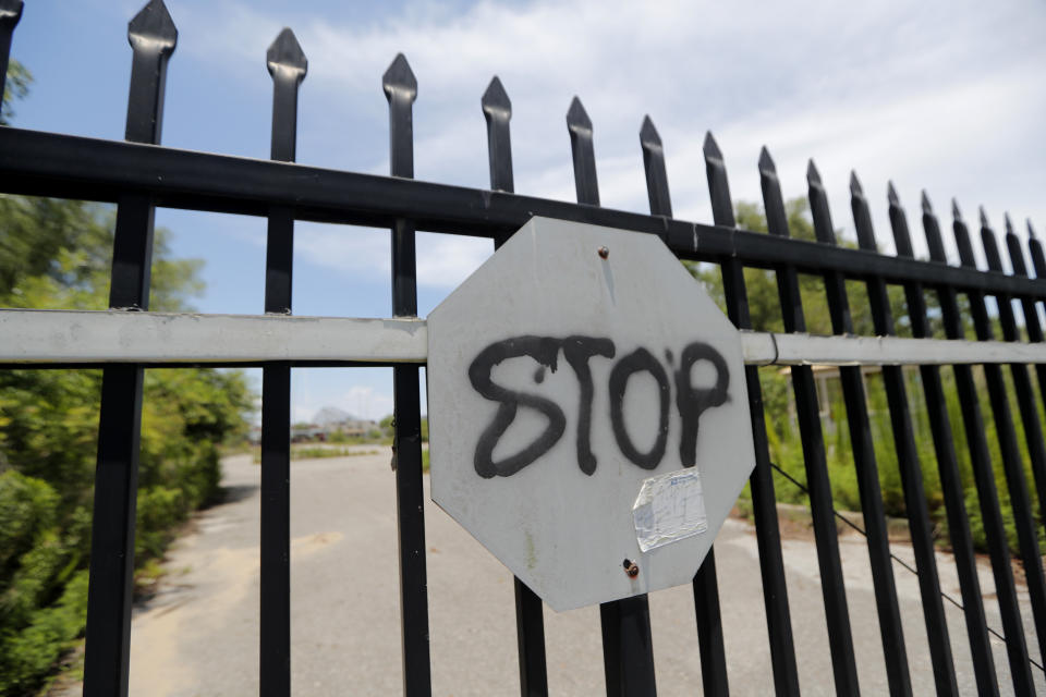 This June 19, 2019, photo shows the gates of the abandoned Six Flags Great Adventure Amusement Park in New Orleans. The abandoned New Orleans amusement park that has stood empty since Hurricane Katrina in 2005 may finally be torn down. The Six Flags park never reopened after the levees failed and flooded the city with water. Mayor LaToya Cantrell says her office is targeting the site for demolition. (AP Photo/Gerald Herbert)