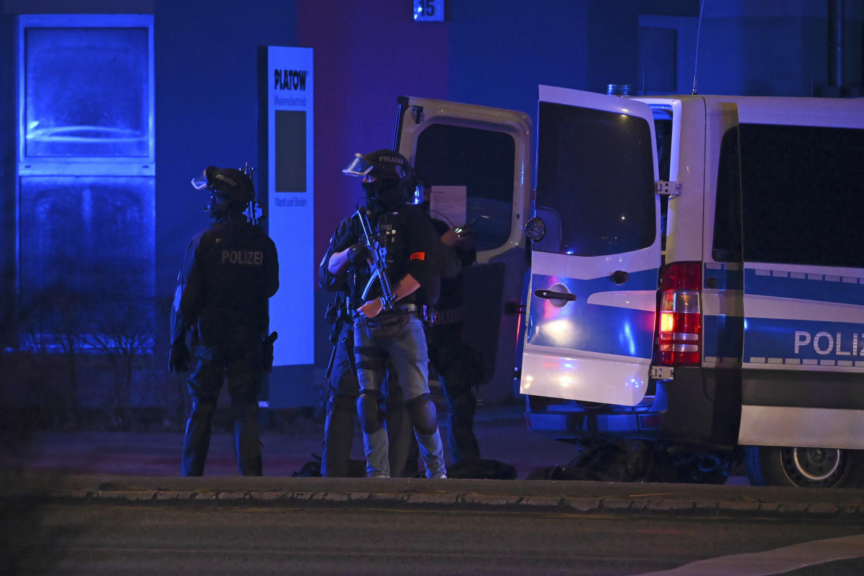 Armed police officers near the scene of a shooting in Hamburg, Germany on Thursday March 9, 2023 after one or more people opened fire in a church. The Hamburg city government says the shooting took place in the Gross Borstel district on Thursday evening. (Jonas Walzberg/dpa via AP)