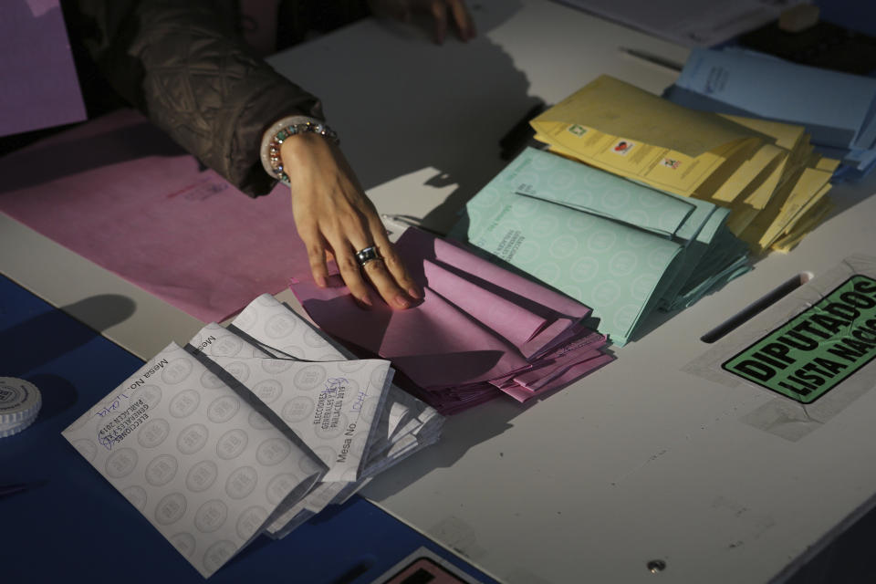 An electoral official keeps empty ballots organized during general elections in Guatemala City, Sunday, June 16, 2019. Guatemalans vote for their next president Sunday in elections plagued by widespread disillusion and distrust, and as thousands of their compatriots flee poverty and gang violence to seek a new life in the United States. (AP Photo/Oliver de Ros)