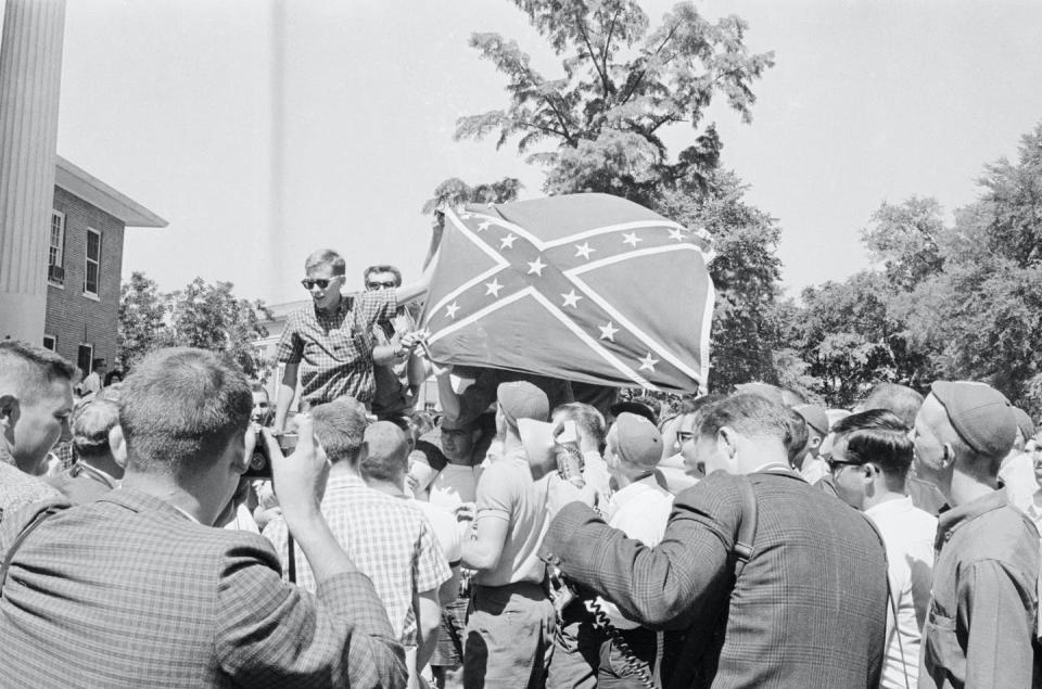 University of Mississippi students hold a Confederate battle flag