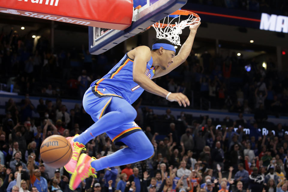 FILE - Oklahoma City Thunder forward Darius Bazley (7) dunks the ball during the final moments of an NBA basketball game against the Los Angeles Lakers, Wednesday, Oct. 27, 2021, in Oklahoma City. After high school, Bazley skipped college and took a $1 million internship with New Balance for a year before jumping into the NBA. He was the 23rd pick in the 2019 draft and now, he's a starter for the Oklahoma City Thunder. (AP Photo/Garett Fisbeck, File)