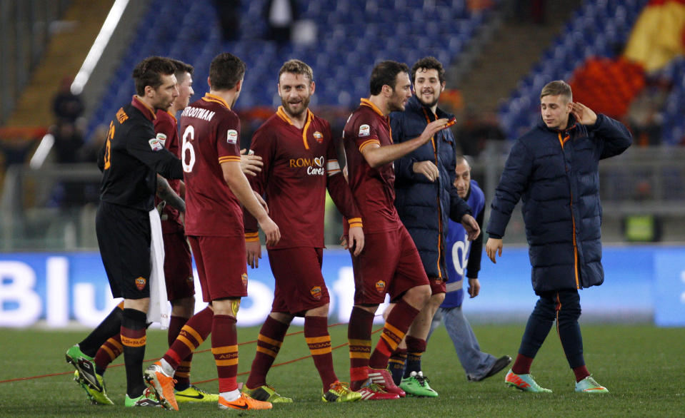 AS Roma players, including Kevin Strootman, third from left, and Daniele De Rossi, center, celebrate at the end of a Serie A soccer match between AS Roma and Sampdoria, at Rome's Olympic stadium, Sunday, Feb. 16, 2014. AS Roma won 3-0. (AP Photo/Riccardo De Luca)