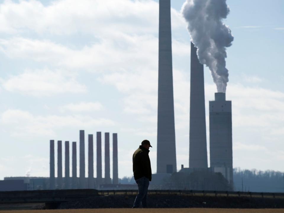With the TVA Kingston Fossil Fuel Plant in the background, Brian Thacker stands at the Swan Pond Sports Complex on Dec. 22, 2018, on the 10th anniversary of the Plant's coal ash spill. Thacker, who operated a dredge and heavy machinery, joined hundreds of other coal ash clean-up workers, family, and friends to honor the more than 30 dead and 250 sick or dying coal ash disaster relief workers in a memorial service.