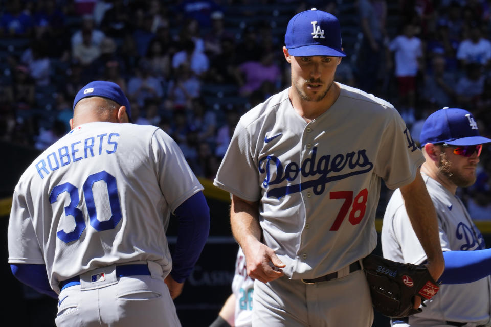 Los Angeles Dodgers starting pitcher Michael Grove (78) walks off the field after being taking out by Dodgers manager Dave Roberts (30) during the fourth inning of a baseball game against the Arizona Diamondbacks Sunday, April 9, 2023, in Phoenix. (AP Photo/Ross D. Franklin)