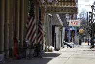 Bill Kramer sits in front of Links Tavern, Thursday, April 2, 2020, in Greensburg, Ind. Decatur County is among three neighboring southeastern Indiana counties that all have confirmed COVID-19 cases among the highest per-capita rates in the country. (AP Photo/Darron Cummings)