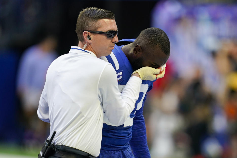 Indianapolis Colts linebacker Shaquille Leonard is helped off the field after an injury in the first half of an NFL football game against the Tennessee Titans in Indianapolis, Fla., Sunday, Oct. 2, 2022. (AP Photo/Darron Cummings)