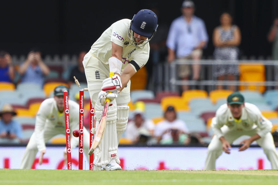 England's Rory Burns is out bowled first ball during day one of the first Ashes cricket test at the Gabba in Brisbane, Australia, Wednesday, Dec. 8, 2021. (AP Photo/Tertius Pickard)
