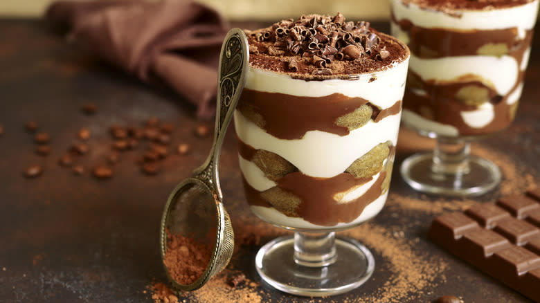 tiramisu in serving glasses with coffee beans and shaved chocolate