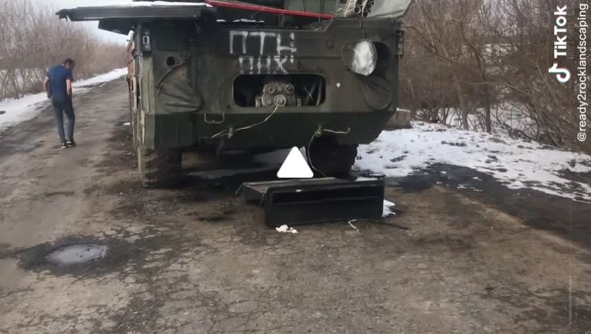 Joe McCarthy inspects an abandoned military vehicle they came across en route to Sumy, Ukraine, to help fleeing refugees (Tik Tok)