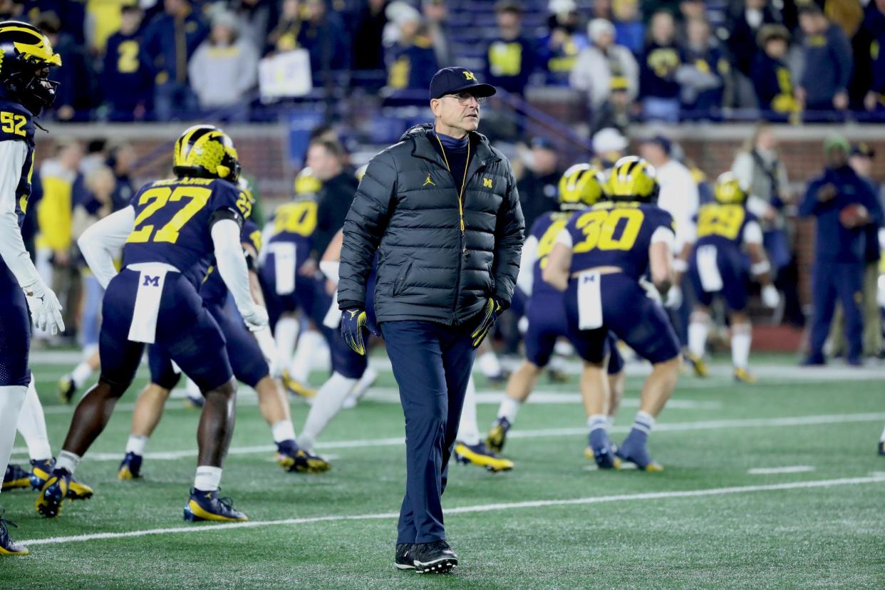 Michigan Wolverines head coach Jim Harbaugh watches his team warm up before action against the Purdue Boilermakers at Michigan Stadium, Saturday, Nov. 4, 2023.