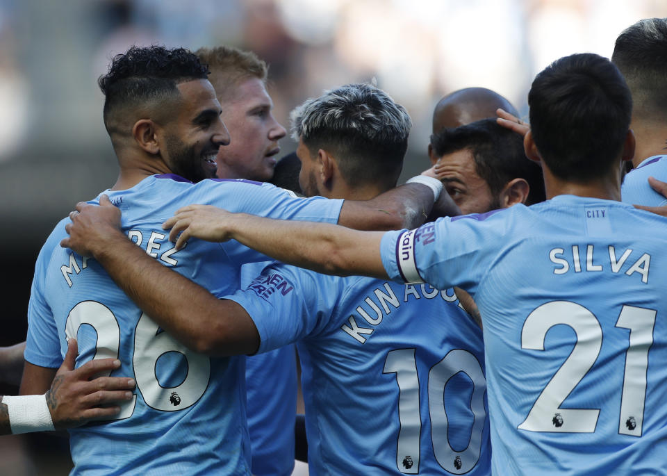 Manchester City's Riyad Mahrez, left, celebrates with teammates after scoring his sides third goal during the English Premier League soccer match between Manchester City and Watford at Etihad stadium in Manchester, England, Saturday, Sept. 21, 2019. (AP Photo/Rui Vieira)