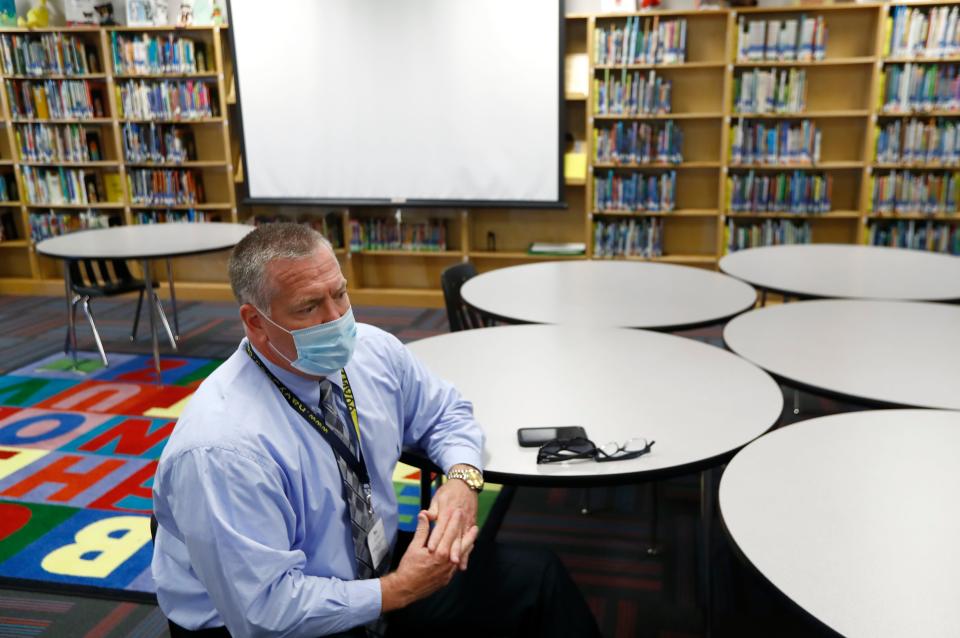 Millington Municipal Schools Superintendent Bo Griffin wears a protective face mask as he sits in the Millington Elementary School library on the first day of class Monday, August 10, 2020.