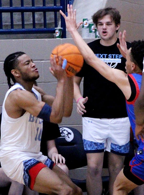 Bartlesville High's David Castillo, left, looks to launch a three-pointer during a 35-point outburst on Jan. 7, 2023, against Millwood High, at the ConocoPhillips/Arvest Invitational.