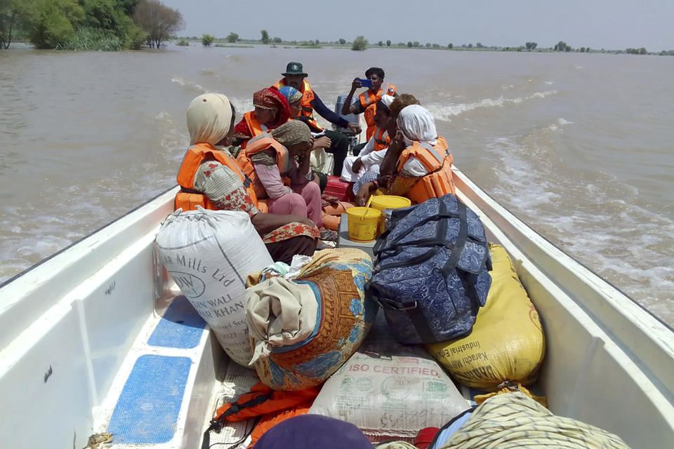 In this photo released by Rescue 1122 Emergency Department, rescue workers use a boat to evacuate villagers from a flooded area of Bahawalnagar district in Pakistan's Punjab province, Wednesday, Aug. 23, 2023. Rescuers have evacuated more than 100,000 people from flood-hit areas of Pakistan's eastern Punjab province in the past three weeks, officials said Wednesday. (Rescue 1122 Emergency Department vis AP)