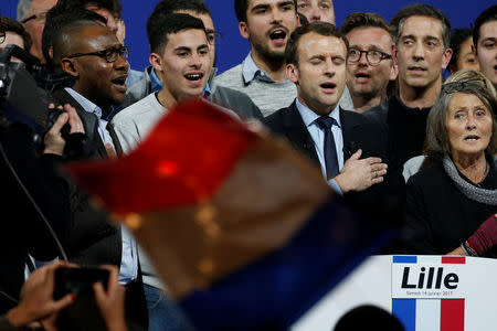 Emmanuel Macron, head of the political movement En Marche !, or Forward !, and candidate for the 2017 French presidential election, sings the French national anthem at the end of a political rally in Lille, France January 14, 2017. REUTERS/Pascal Rossignol