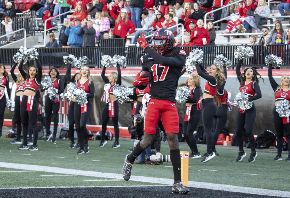 Western Kentucky wide receiver Dalvin Smith runs the ball into the end zone for a touchdown against Sam Houston during an NCAA college football game Saturday, Nov. 18, 2023, in Bowling Green, Ky. (Grace Ramey/Daily News via AP)