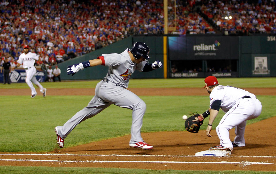 ARLINGTON, TX - OCTOBER 23: Jon Jay #19 of the St. Louis Cardinals is thrown out at first base by Elvis Andrus #1 of the Texas Rangers in the third inning during Game Four of the MLB World Series at Rangers Ballpark in Arlington on October 23, 2011 in Arlington, Texas. (Photo by Tom Pennington/Getty Images)