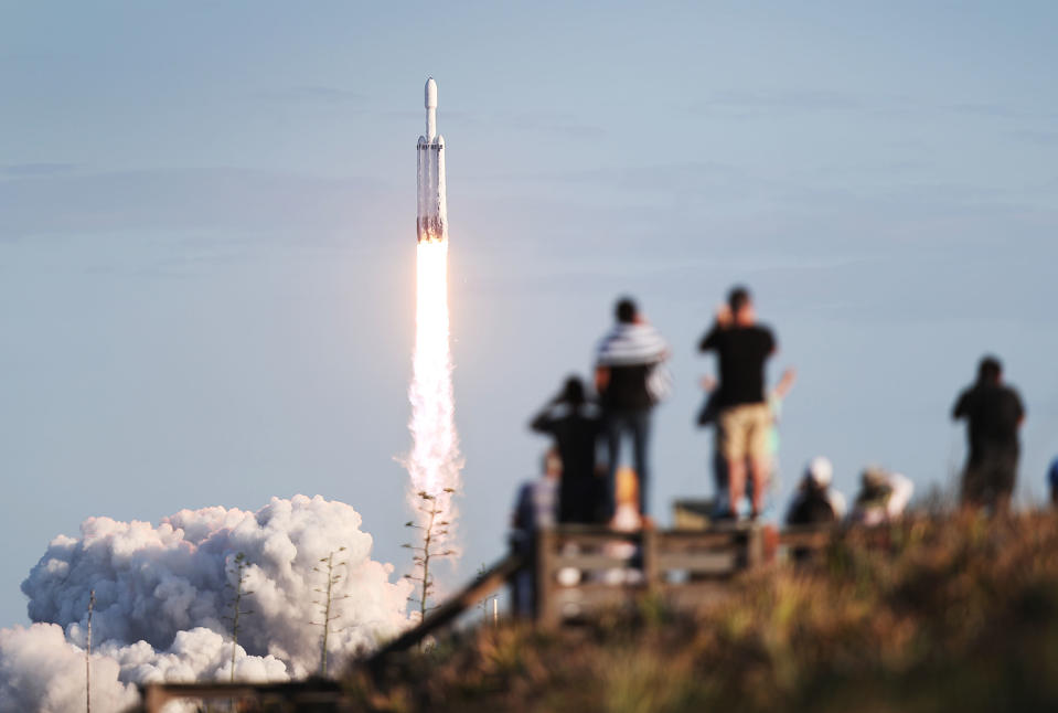 TITUSVILLE, FLORIDA - APRIL 11: People watch as the SpaceX Falcon Heavy rocket lifts off from launch pad 39A at NASA’s Kennedy Space Center on April 11, 2019 in Titusville, Florida. The rocket is carrying a communications satellite built by Lockheed Martin into orbit. (Photo by Joe Raedle/Getty Images)