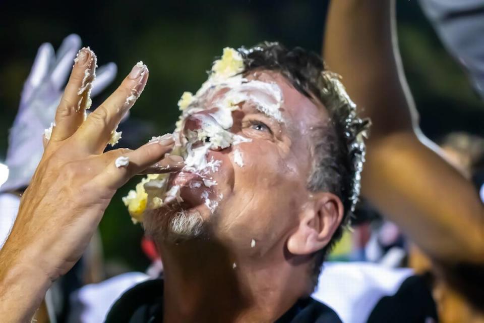 Butler Headcoach Brian Hales take a win and a pie in the face on the field after beating Charlotte Catholic Kelly Hood