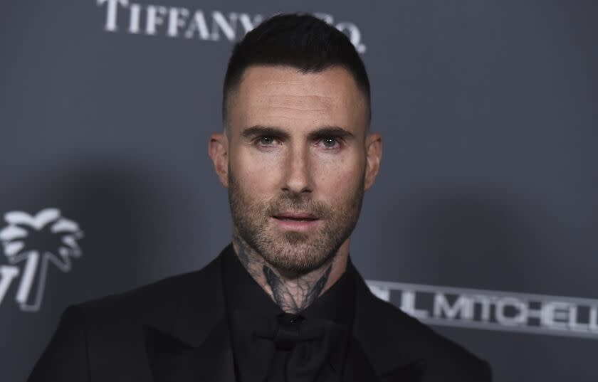 Adam Levine looks directly at the camera