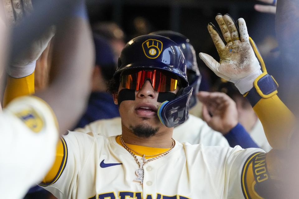 Milwaukee Brewers' William Contreras is congratulated after hitting a three-run home run during the third inning of a baseball game against the Pittsburgh Pirates Wednesday, May 15, 2024, in Milwaukee. (AP Photo/Morry Gash)