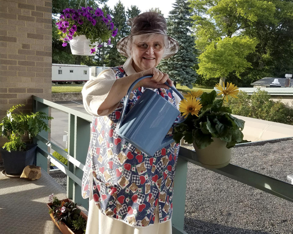 In this photo provided by Sister Mary Jeanine Morozowich, Felician Sister Mary Evelyn Labik waters flowers at St. Anne Home in Greensburg, Pa., on June 22, 2020. Labik died after contracting COVID-19 last October. (Sister Mary Jeanine Morozowich via AP)