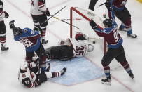 Arizona Coyotes' goalie Darcy Kuemper (35) is scored on as Colorado Avalanche's Gabriel Landeskog (92) and Mikko Rantanen (96) celebrate during the third period of a first-round NHL Stanley Cup playoff hockey game in Edmonton, Ontario, on Wednesday, Aug. 12, 2020. (Jason Franson/The Canadian Press via AP)