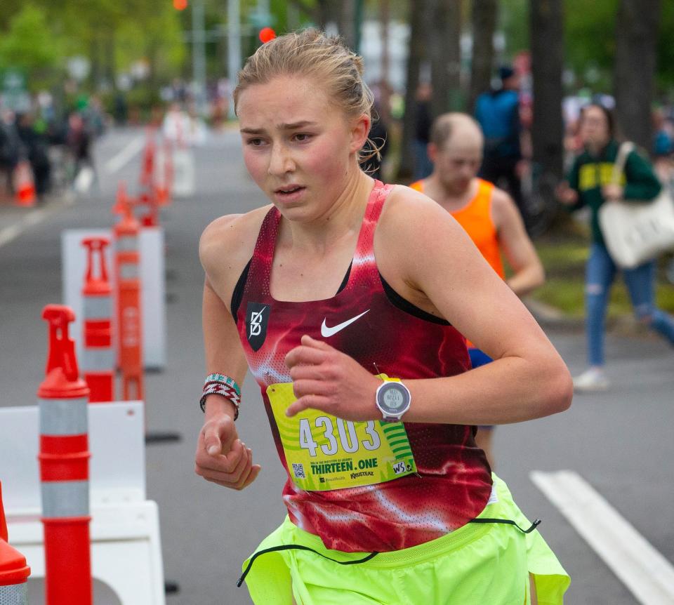 Kate Peters, a junior from Lake Oswego High School, enters Hayward Field from Agate Street on her way to winning the women's half marathon during the 2022 Eugene Marathon in Eugene Sunday.