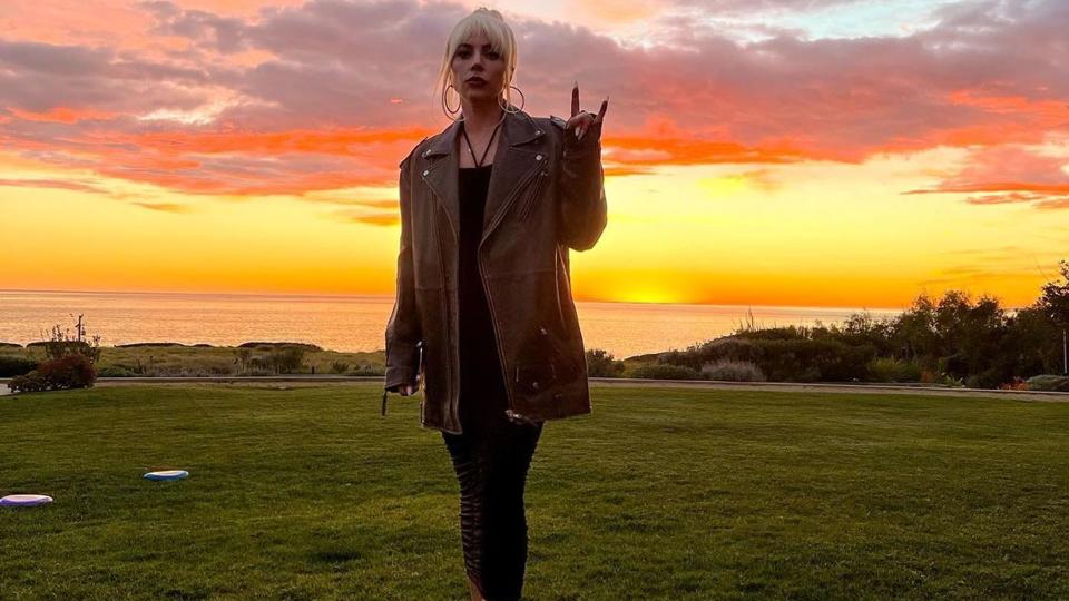 Lady Gaga against the backdrop of the sunset over the ocean