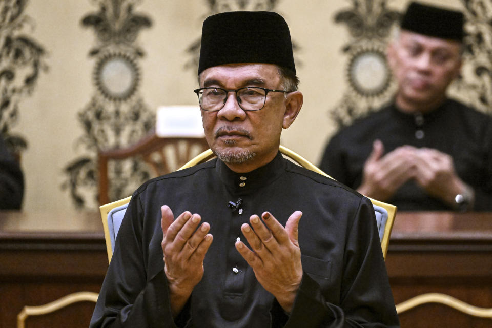 Malaysia's newly appointed Prime Minister Anwar Ibrahim offers prayers after taking the oath during the swearing-in ceremony at the National Palace in Kuala Lumpur, Malaysia, Thursday, Nov. 24, 2022. Malaysia's king on Thursday named Anwar as the country's prime minister, ending days of uncertainty after the divisive general election produced a hung Parliament. (Mohd Rasfan/Pool Photo via AP)