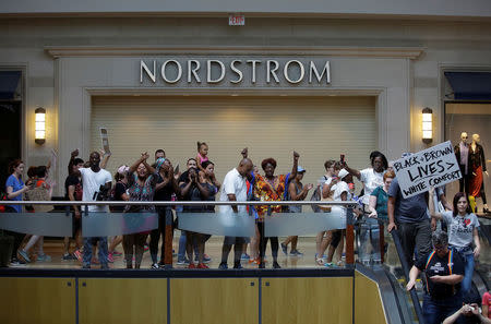 People march through West County Mall a day after the not guilty verdict in the murder trial of Jason Stockley, a former St. Louis police officer, charged with the 2011 shooting of Anthony Lamar Smith, who was black, in St. Louis, Missouri, U.S., September 16, 2017. REUTERS/Joshua Lott
