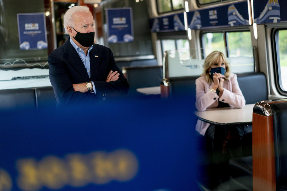 Democratic presidential candidate former Vice President Joe Biden and his wife Jill Biden, right, speak with invited guests aboard an Amtrak train, Wednesday, Sept. 30, 2020, as it makes its way to Alliance, Ohio. Biden is on a train tour through Ohio and Pennsylvania today. (AP Photo/Andrew Harnik)