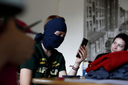 An attendee prepares a face veil during a meeting at Folkets Hus, which translates to People's House, to prepare for a protest ahead of the face veil ban in Copenhagen, Denmark, July 23, 2018. REUTERS/Andrew Kelly