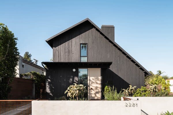 The front of the renovated property features clean lines and few materials to not overwhelm its corner of the neighborhood.