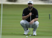 Jon Rahm, of Spain, lines up a putt on the 18th green during a practice round of the Hero World Challenge PGA Tour at the Albany Golf Club, in New Providence, Bahamas, Wednesday, Nov. 30, 2022. (AP Photo/Fernando Llano)