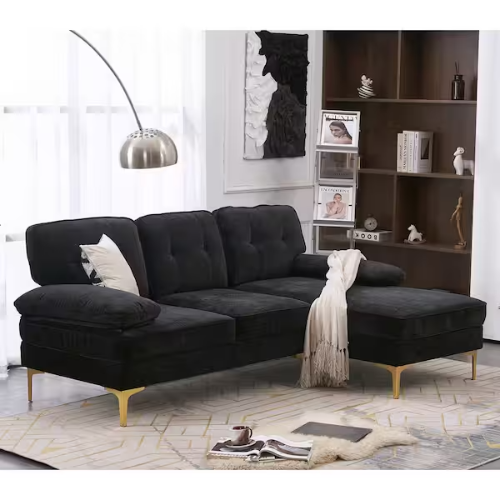 black 3-seat sofa with chaise in against window with bookshelf next to it