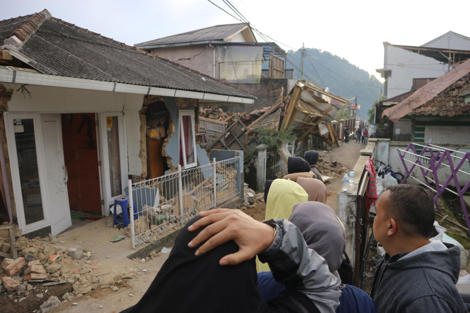 Residents react as they inspect houses damaged by Monday's earthquake in Cianjur, West Java, Indonesia Tuesday, Nov. 22, 2022. The earthquake has toppled buildings on Indonesia's densely populated main island, killing a number of people and injuring hundreds. (AP Photo/Rangga Firmansyah)