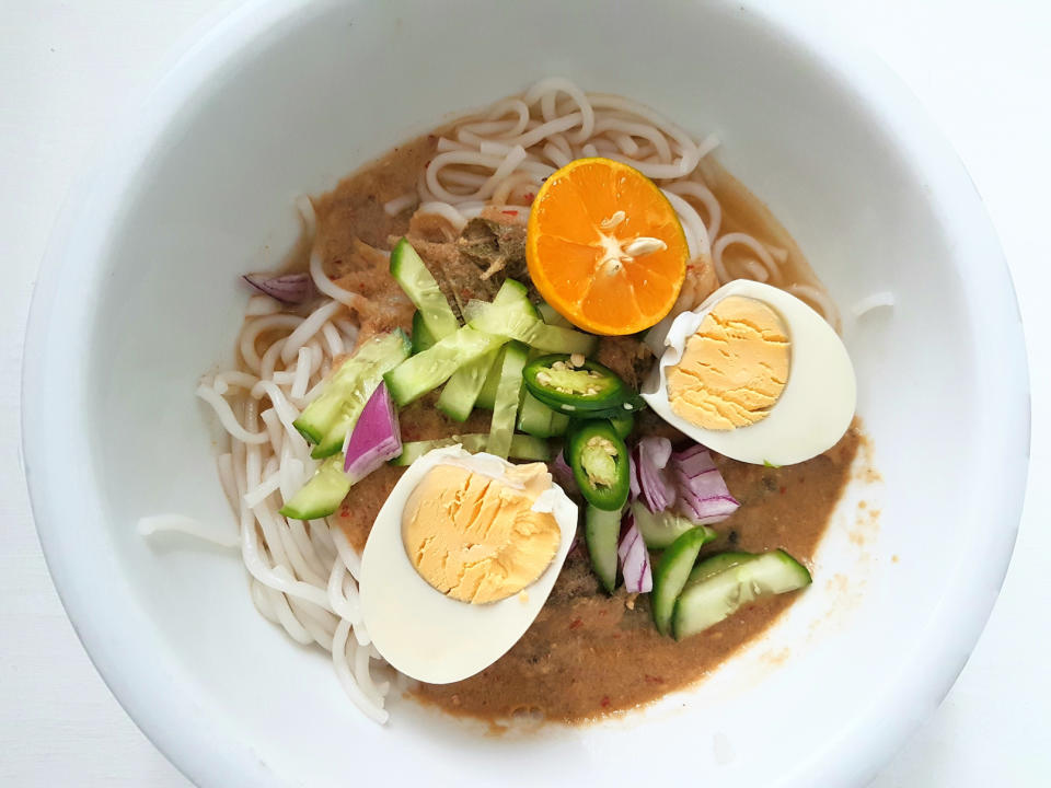  Malaysian Assam Laksa with its ingredients in a white bowl