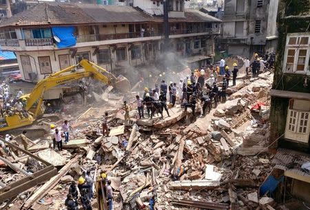 FILE PHOTO: Firefighters and rescue workers search for survivors at the site of a collapsed building in Mumbai, India, August 31, 2017. REUTERS/Shailesh Andrade/File Photo