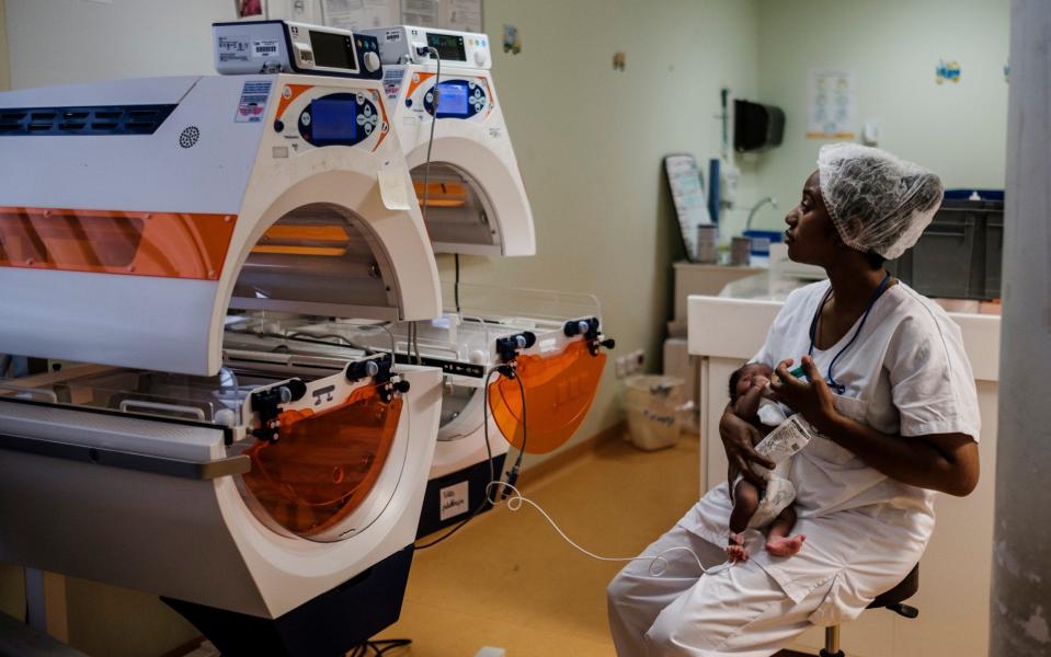 A nurse feeds a newborn in the Central Hospital of Mayotte - Â© Eduardo Soteras Jalil/The Daily Telegraph