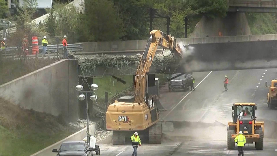 In this photo made from video, a demolition crew begins work on tearing down the Fairfield Avenue bridge, Friday, May 3, 2024, in Norwalk, Conn. Workers have begun removing the bridge over I-95 that was damaged in a fiery crash involving a gasoline tanker truck on Thursday. The demolition is expected to keep both sides of Interstate 95 in Norwalk closed through the weekend. (WABC TV via AP))