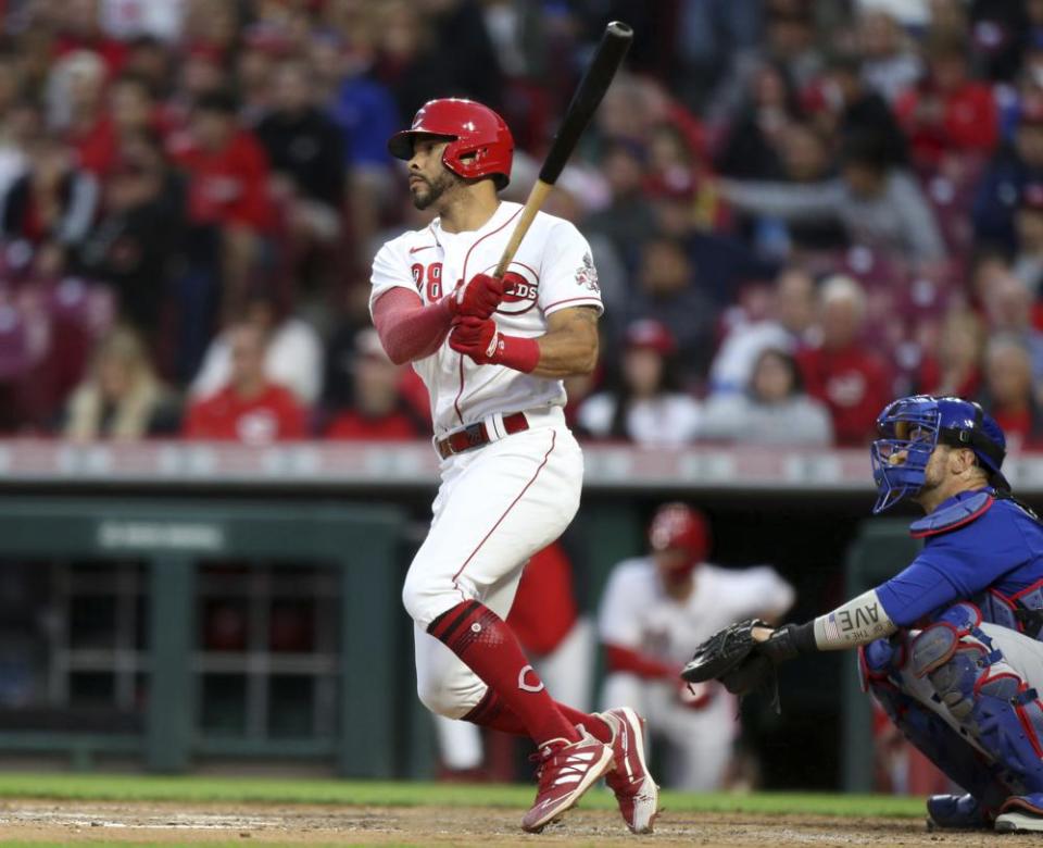 Cincinnati Reds’ Tommy Pham, left, watches his home run in front of Chicago Cubs catcher Yan Gomes during the sixth inning of a baseball game in Cincinnati, Monday, May 23, 2022. (AP Photo/Paul Vernon)