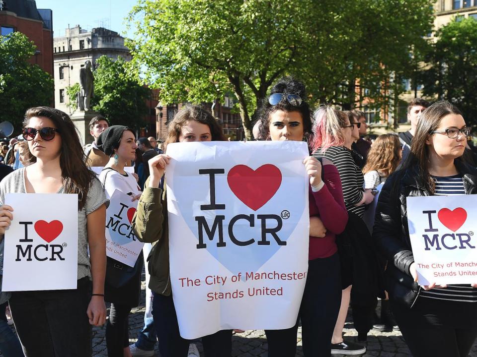 People attend a vigil for the people who lost their lives during the Manchester terror attack in central Manchester (EPA)