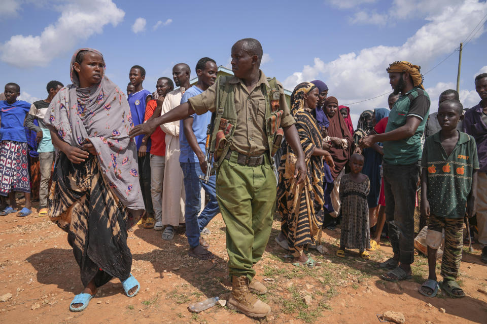 Residents gather for a planned distribution of food, after El Niño rains damaged their houses in Mandera County, Kenya, Wednesday, Dec. 13, 2023. Rains began pounding the country in October. At the end of November Kenya President William Ruto convened an emergency cabinet meeting saying 38 of Kenya’s 47 counties had been affected by floods and mudslides made worse by the El Niño phenomenon. (AP Photo/Brian Inganga)