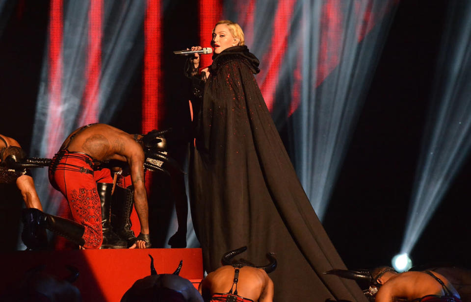 Madonna in a custom Armani cape performing at the Brit Awards. 