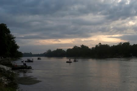 People cross the Suchiate river from Tecun Uman, in Guatemala, to Ciudad Hidalgo, as seen from Ciudad Hidalgo