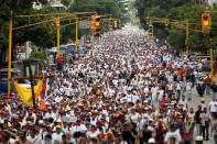 Demonstrators take part in a rally to honour victims of violence during a protest against Venezuela's President Nicolas Maduro's government in Caracas. REUTERS/Christian Veron