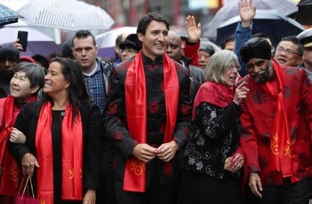 Canada's Prime Minister Justin Trudeau along with Jody Wilson-Raybould, Minister of Justice and Harjit Sajjan, Minister of National Defence, wave to the crowd at a Chinese New Year parade in Vancouver, B.C., Canada January 29, 2017. REUTERS/Ben Nelms