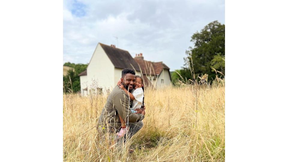 jb gill hugging daughter outside farmhouse